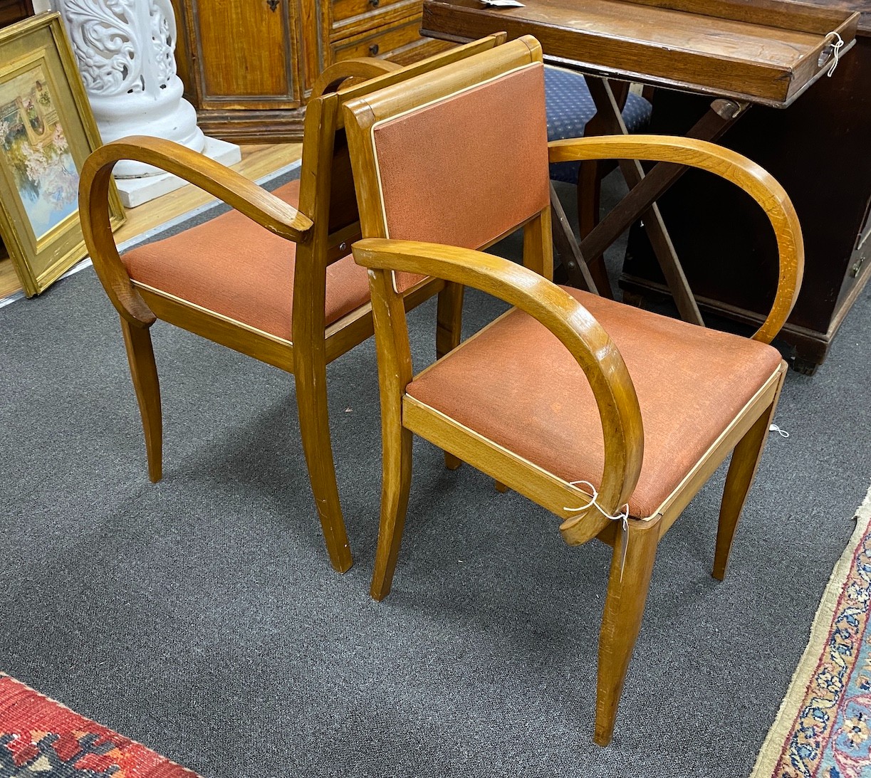 A pair of 1950s French beech Bridge elbow chairs